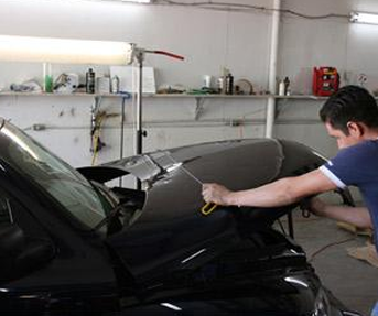 Mechanic Repairing Dent in Fort Worth, TX 